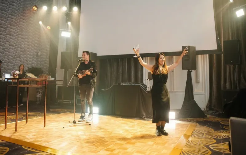 Pim and Milan on stage, Pim with arms raised